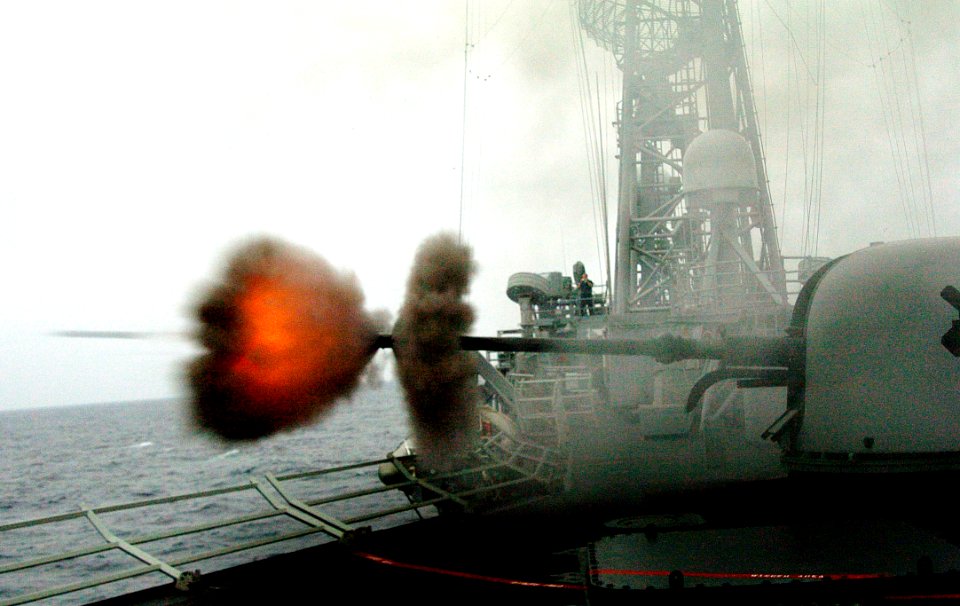 US Navy 040714-N-1464F-001 A round is fired from the ship's MK-75 76mm gun aboard the guided missile frigate USS Crommelin (FFG 37)
