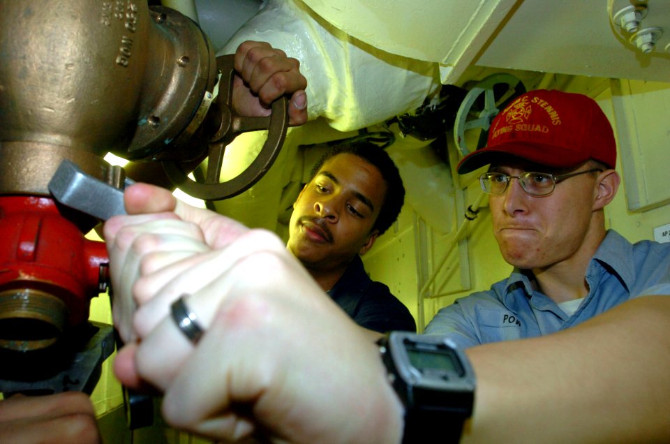 US Navy 040812-N-7732W-052 Damage Control Fireman Joseph Jones from Pomona, Calif., and Damage Control Fireman Daniel Powell from Huntington Beach, Calif., perform periodic maintenance on a fire station