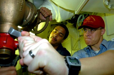 US Navy 040812-N-7732W-052 Damage Control Fireman Joseph Jones from Pomona, Calif., and Damage Control Fireman Daniel Powell from Huntington Beach, Calif., perform periodic maintenance on a fire station