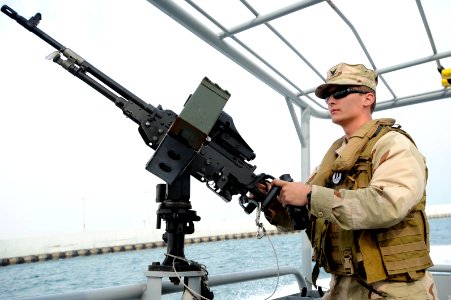 US Navy 120107-N-RP435-709 Gunner's Mate 3rd Class Matthew Woods mans a .50-caliber machine gun aboard a U.S. Navy coastal patrol boat during a pat