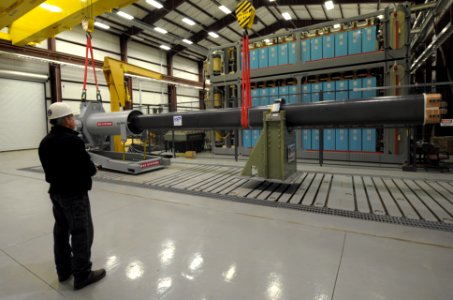 US Navy 120130-N-PO203-090 A government worker uses a crane to maneuver a 32-MJ version of the Office of Naval Research-funded Electromagnetic Rail