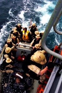 US Navy 040720-N-1464F-003 A boarding team from USS Thomas S. Gates (CG 51) climbs aboard a Rigid Inflatable Boat (RIB) to conduct a boarding of a foreign amphibious ship during Pacific Phase exercises of UNITAS 45-04