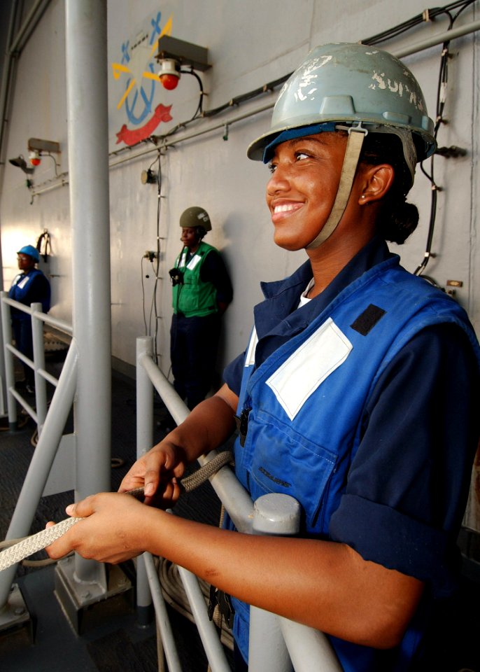 US Navy 040724-N-4374S-005 A Sailor mans a forward tending line on the starboard boat davit during small boat operations aboard the conventionally powered aircraft carrier USS John F. Kennedy (CV 67)