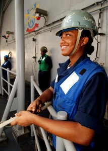 US Navy 040724-N-4374S-005 A Sailor mans a forward tending line on the starboard boat davit during small boat operations aboard the conventionally powered aircraft carrier USS John F. Kennedy (CV 67)