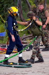 US Navy 040719-N-6811L-064 Lt. Cmdr. Gregory Hubbard is assisted by Quartermaster 1st Class Ryan Stewart during diving salvage operations training