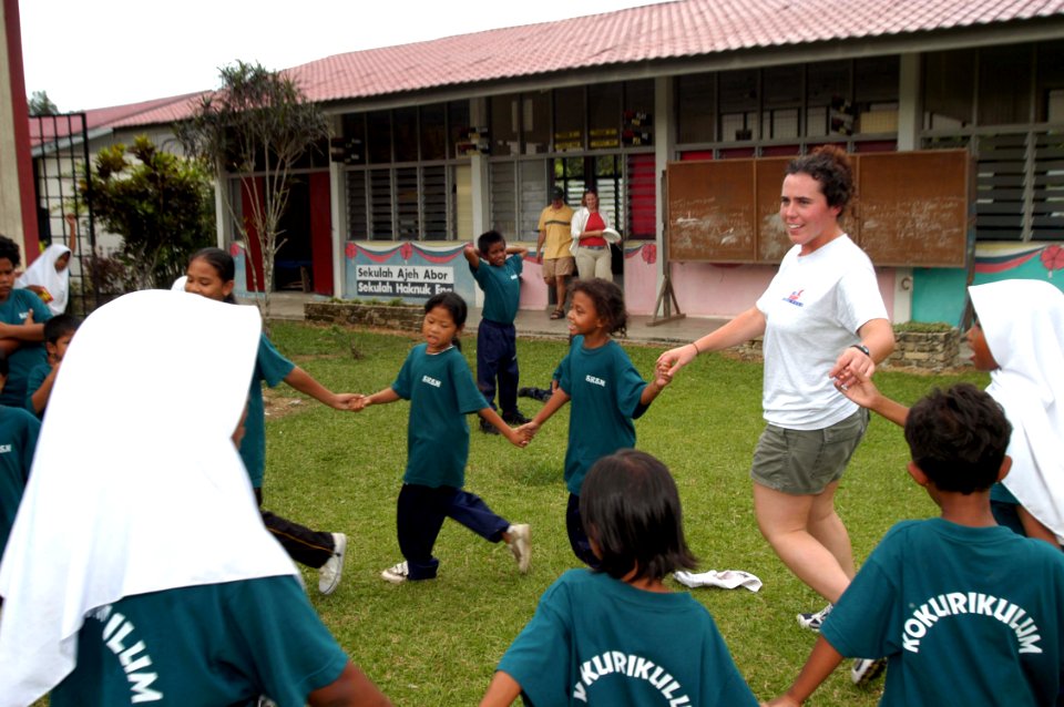 US Navy 040714-N-4104L-004 Lt.j.g. Sarah Heidt, anti-submarine warfare officer aboard USS McCampbell (DDG 85), plays a schoolyard game with Aboriginal students in Sungai Jin, Malaysia