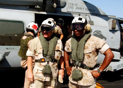 US Navy 040820-N-4374S-005 Master Chief Petty Officer of the Navy (MCPON) Terry Scott and Sergeant Major of the Marine Corps John Estrada exit from HH-60H Seahawk helicopter