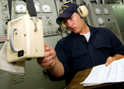 US Navy 040731-N-4374S-008 Fireman Joseph Dever performs a heat index survey in the auxiliary machinery room while standing a sound and security watch aboard the mine countermeasure ship USS Dextrous (MCM 13)