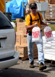 US Navy 040817-N-0000A-001 Senior Chief Hospital Corpsmen Donald B. Abele helps pass out ice to citizens of South Florida at an aid station set up by the Federal Emergency Management Agency (FEMA)