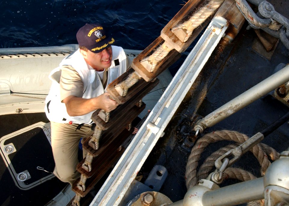 US Navy 040722-N-4374S-007 Commander, Destroyer Squadron Two Four (COMDESRON 24), Capt. Anthony Kurta, climbs up on a ladder to the British Duke-class frigate HMS Somerset (F 82)
