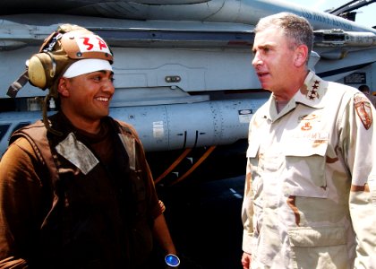 US Navy 040719-N-4374S-006 A member of the flight deck crew speaks with General John Abizaid, Commander, U.S. Central Command, on the flight deck of USS John F. Kennedy (CV 67)