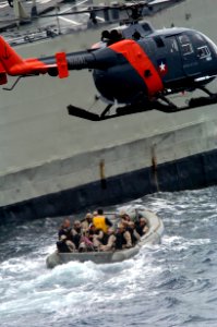 US Navy 040720-N-1464F-007 A boarding team from USS Thomas S. Gates (CG 51) rides a Rigid Hull Inflatable Boat (RHIB) as it prepares to conduct a boarding of a foreign amphibious ship during Pacific Phase exercises of UNITAS 4