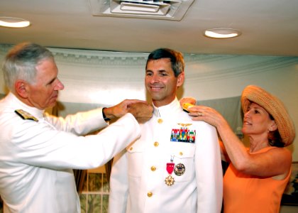 US Navy 040728-N-4614W-200 Vice Adm. James M. Zortman, center, receives new three star shoulder boards during his promotion ceremony to Vice Admiral, from Commander, United States Fleet Forces Command, Adm. William J. Fallon, a