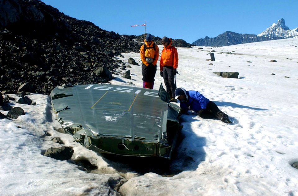 US Navy 040809-N-0331L-002 Recovery personnel examine the wreckage of a Navy P-2V Neptune aircraft that crashed over Greenland in 1962