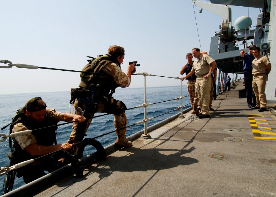 US Navy 040722-N-4374S-015 Commander, Destroyer Squadron Two Four (COMDESRON 24), Capt. Anthony Kurta and Lt. Shane Crockett, observe the boarding procedures demonstrated by the British Royal Marines aboard the frigate HMS Some
