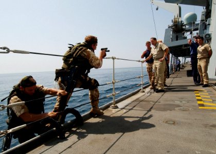 US Navy 040722-N-4374S-015 Commander, Destroyer Squadron Two Four (COMDESRON 24), Capt. Anthony Kurta and Lt. Shane Crockett, observe the boarding procedures demonstrated by the British Royal Marines aboard the frigate HMS Some