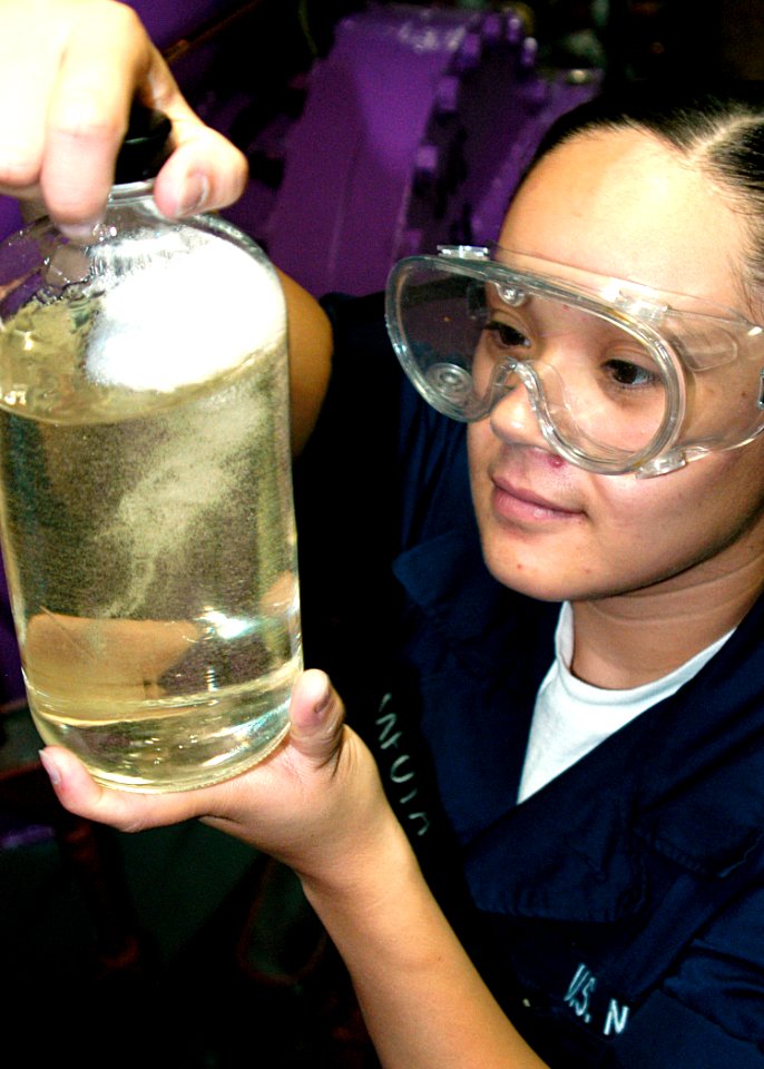 US Navy 040626-N-2972R-058 Airman Erica Tafoya, of Anaheim, Calif., tests a JP-5 fuel sample aboard the amphibious assault ship USS Kearsarge (LHD 3)