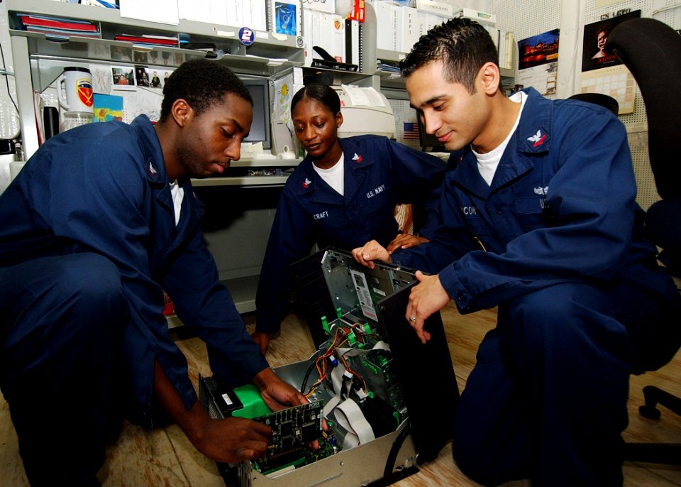 US Navy 040904-N-4374S-007 Sailors assigned to Commander, Carrier Group Six (CCG-6), perform troubleshooting on a computer aboard the conventionally powered aircraft carrier USS John F. Kennedy (CV 67)