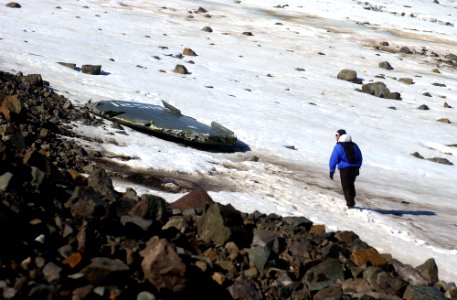US Navy 040807-N-0331L-008 Lt. Cdr. Christopher Blow walks across the snow to examine the wreckage of a Navy P-2V Neptune aircraft that crashed over Greenland in 1962