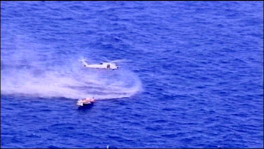 US Navy 040814-N-0000X-002 an SH-60F Seahawk belonging to the Red Lions of Helicopter anti-submarine Squadron Fifteen (HS-15) hovering over the Iranian dhow Naji