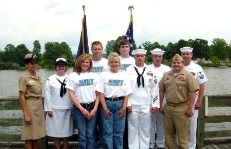 US Navy 040910-N-0000X-003 U.S. Navy Active duty and Reserve recruiters take a moment to congratulate and pose for a group picture with four of the Navy's newest Sailors