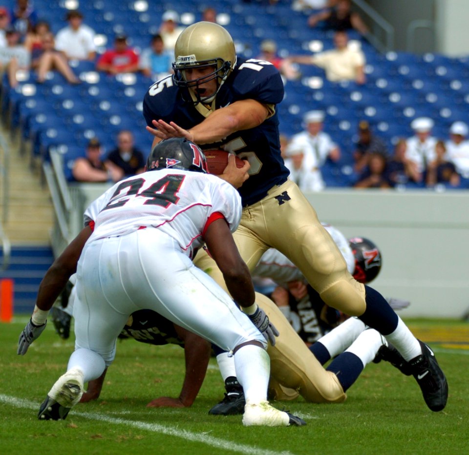 US Navy 040911-N-9693M-015 U.S. Naval Academy Midshipman 1st Class Frank Divis gains yardage against the Northeastern Huskies' EJ Jackson