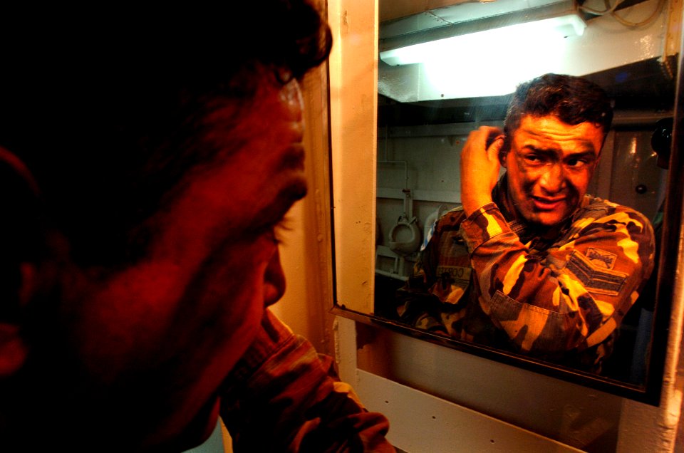 US Navy 040704-N-1464F-002 Argentinean Marine 1st Cpl. Christian Cortes applies face paint aboard the Peruvian tank landing ship B.A.P. Callao (DT-143) in preparation for the largest amphibious assault exercise