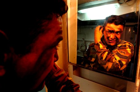 US Navy 040704-N-1464F-002 Argentinean Marine 1st Cpl. Christian Cortes applies face paint aboard the Peruvian tank landing ship B.A.P. Callao (DT-143) in preparation for the largest amphibious assault exercise
