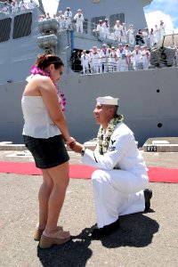 US Navy 040902-N-3228G-010 Sonar Technician 2nd Class Cesar Garcia proposes to his fiancée as his shipmates watch photo