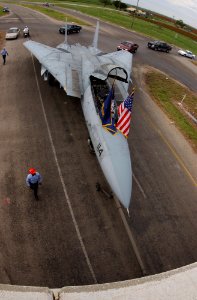 US Navy 040813-F-0017M-002 A decommissioned F-14A Tomcat is towed from San Angelo Regional Airport to Goodfellow Air Force Base, Texas