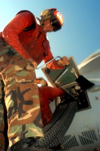 US Navy 040813-N-8704K-002 An Aviation Ordnanceman assigned to the Sunliners of Strike Fighter Squadron Eight One (VFA-81) loads a M-61A1 machine gun prior to flight operations