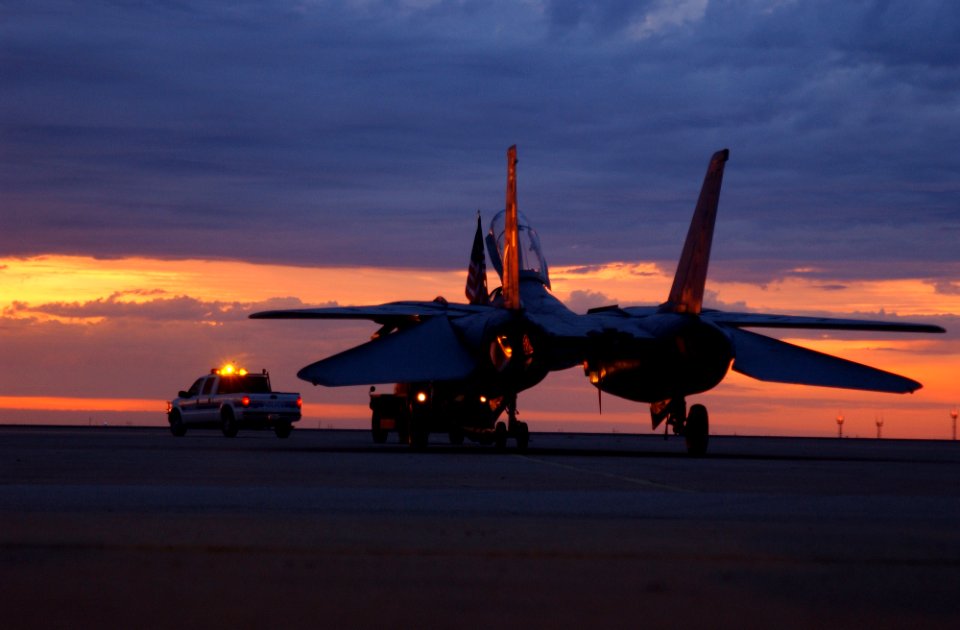 US Navy 040813-F-0017M-001 A decommissioned F-14A Tomcat last assigned to the Checkmates of Fighter Squadron Two One One (VF-211), is towed off the flight line during transportation from San Angelo Regional Airport to Goodfello