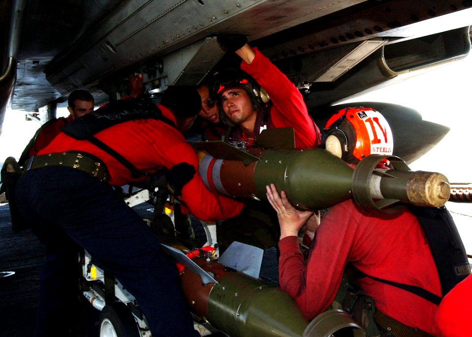 US Navy 040917-N-4374S-011 Aviation Ordnancemen load an Guided Bomb Unit-12 (GBU-12) onto an F-14B Tomcat on the flight deck of the aircraft carrier USS John F. Kennedy (CV 67)