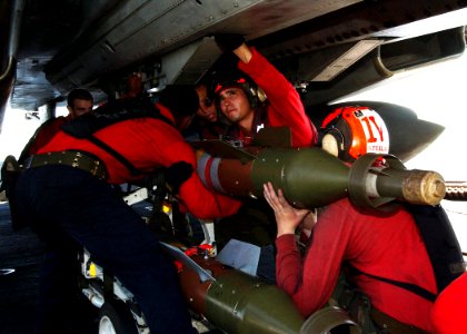 US Navy 040917-N-4374S-011 Aviation Ordnancemen load an Guided Bomb Unit-12 (GBU-12) onto an F-14B Tomcat on the flight deck of the aircraft carrier USS John F. Kennedy (CV 67)