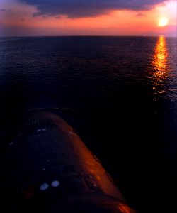 US Navy 040824-N-2653P-003 The sun begins to set as the attack submarine PCU Virginia (SSN 774) heads into port photo