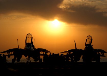 US Navy 040822-N-8704K-002 Maintenance personal assigned to Fighter Squadron One Zero Three (VF-103) complete final checks on two F-14's prior to night flight operations aboard USS John F. Kennedy (CV 67)