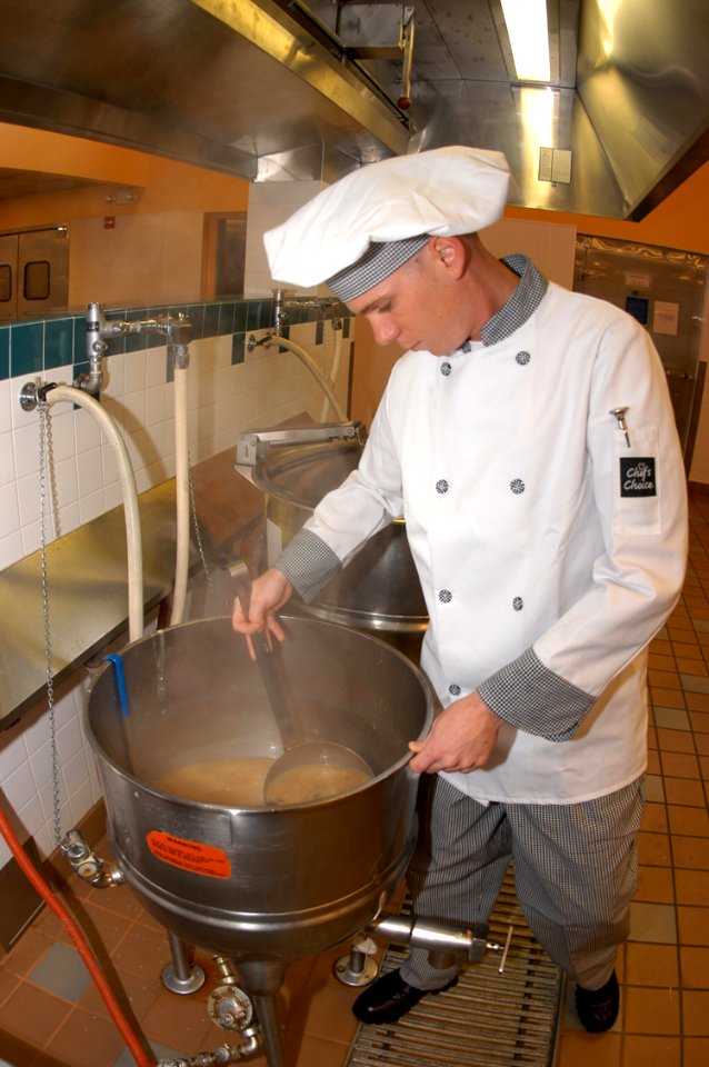 US Navy 040824-N-2976H-003 Culinary Specialist Seaman Recruit Matthew Reikowski prepares soup for the lunchtime meal at the Admiral Nimitz Dining Hall aboard Naval Air Station Whidbey Island