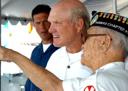 US Navy 040902-N-3019M-002 National Football League (NFL) Hall of Fame quarterback Terry Bradshaw listens to a Pearl Harbor survivor as he describes his experiences aboard USS Missouri