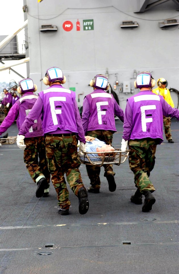 US Navy 040821-N-8158F-004 Crew members participate in a mass casualty drill aboard the flight deck of the nuclear