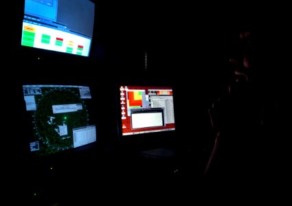 US Navy 040825-N-2653P-001 Fire Control Technician 1st Class Patrick Nogalski monitors the attack submarine PCU Virginia's (SSN 774) radar screens during a surface transit off the coast of Virginia