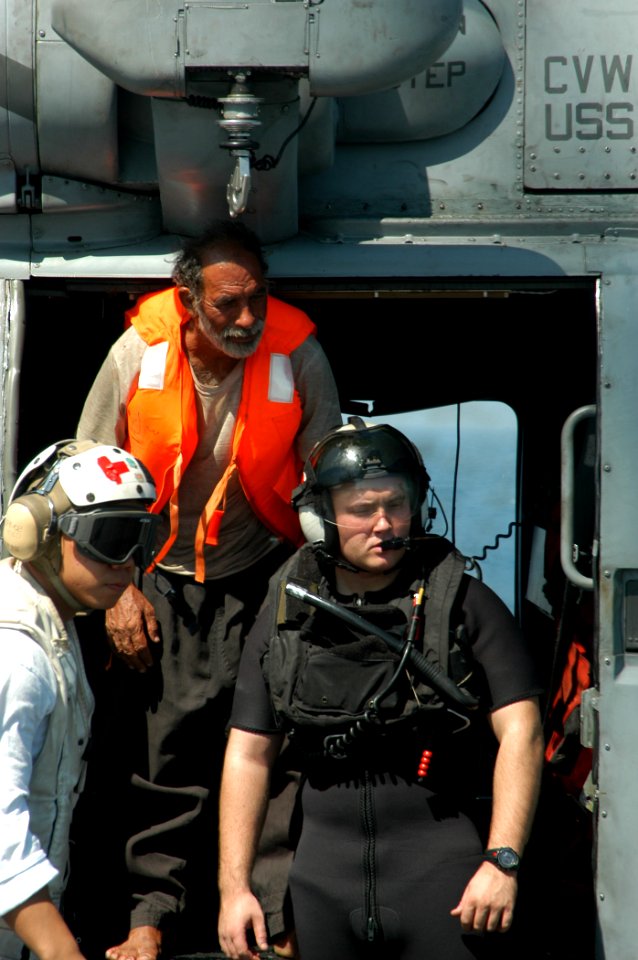US Navy 040814-N-8704K-008 Aboard USS John F. Kennedy (CV 67), medical personnel and a U.S. Navy rescue swimmer assist an Iranian mariner from a Seahawk helicopter assigned to the Red Lions of Helicopter Anti-submarine Squadron