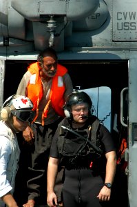 US Navy 040814-N-8704K-008 Aboard USS John F. Kennedy (CV 67), medical personnel and a U.S. Navy rescue swimmer assist an Iranian mariner from a Seahawk helicopter assigned to the Red Lions of Helicopter Anti-submarine Squadron