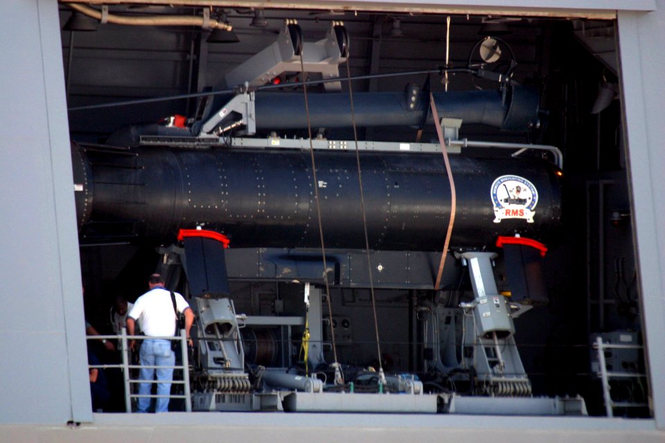 US Navy 040826-N-2354M-005 Engineers work on a Remote Minehunting System (RMS) as it sits in its holding bay on board the Navy's newest guided missile destroyer USS Momsen (DDG 92)