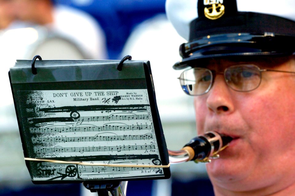 US Navy 040904-N-9693M-002 A U.S. Naval Academy Band musician plays a service song prior to the kick-off in the season home-opener football game