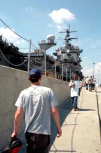 US Navy 040902-N-1464F-004 Sailors walk up the ramp to the nuclear powered aircraft carrier USS Enterprise (CVN 65), moored at pier six aboard Naval Station Norfolk