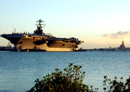 US Navy 040722-N-3019M-004 Tugboats help the Nimitz-class aircraft carrier USS John C. Stennis (CVN 74) moor as it arrives in Pearl Harbor after participating in RIMPAC 2004