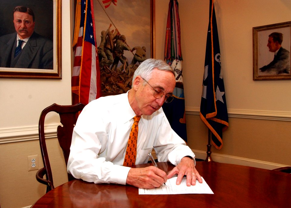 US Navy 040903-N-2568S-001 Secretary of the Navy Gordon R. England takes time to sit down and fill out his absentee ballot for the upcoming national elections