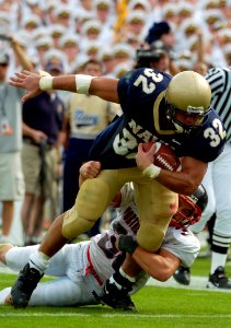 US Navy 040911-N-9693M-003 U.S. Naval Academy Midshipman 1st Class Kyle Eckel is tackled by Northeastern Huskies' Gavin Potter
