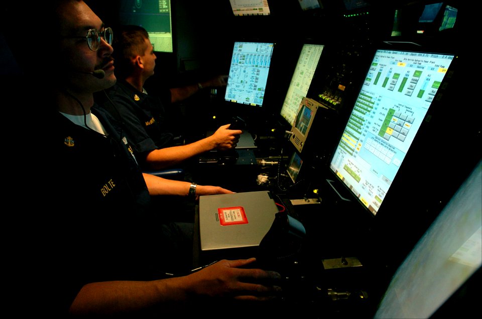US Navy 040822-N-2653P-209 Chief Electronics Technician Jerry Allan Bolte, co-pilot, and Senior Chief Machinist's Mate Scott McIntire, pilot, operate the ship's control panel aboard the attack submarine PCU Virginia