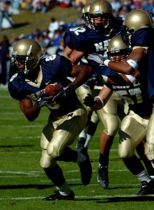 US Navy 041023-N-9693M-003 U.S. Naval Academy slotback Jeremy McGown rushes for yardage in the first quarter against the Rice Owls